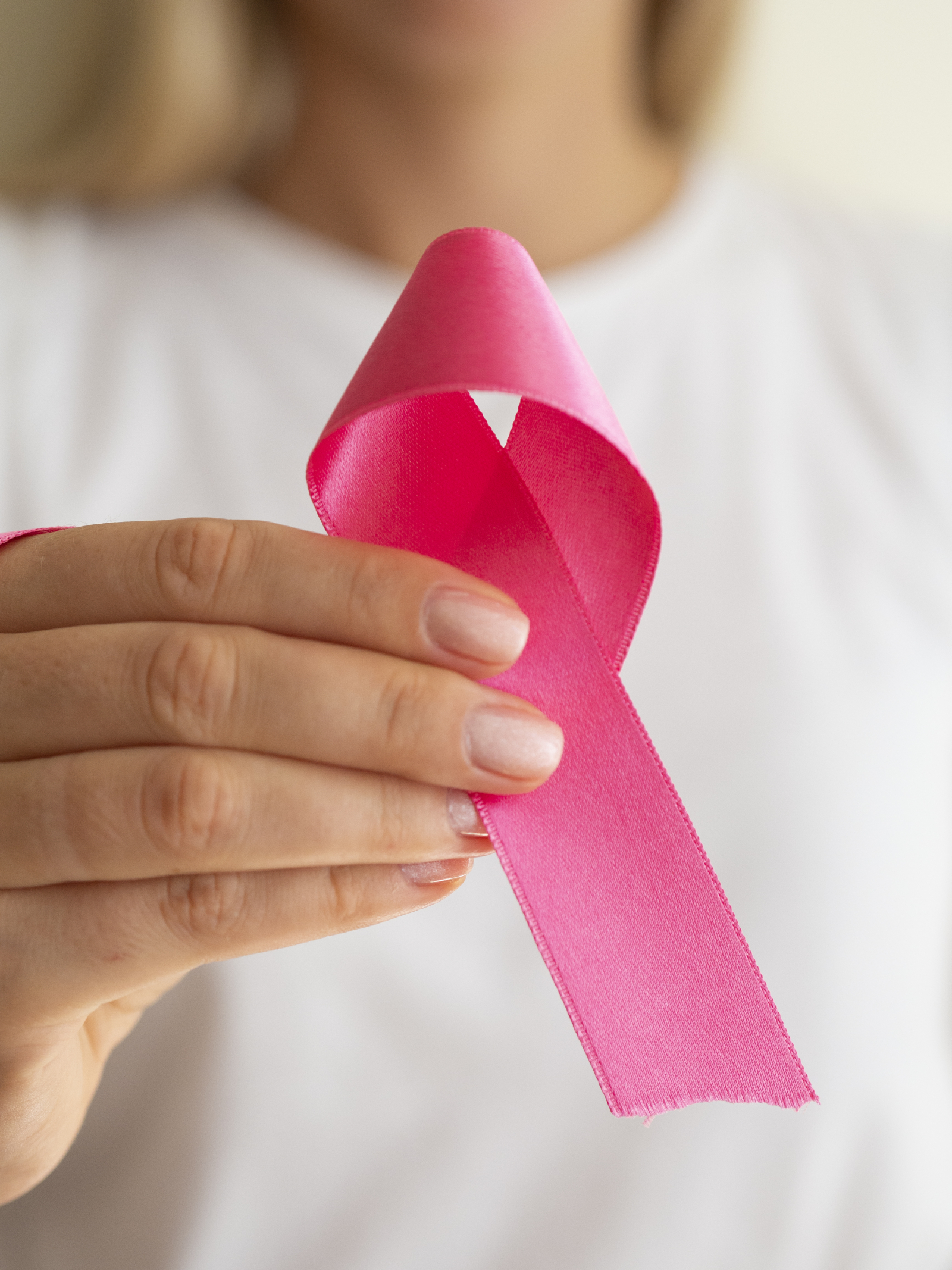 close-up-woman-holding-up-awareness-ribbon